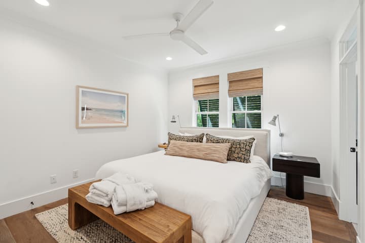 4th bedroom with King bed, shared full bathroom, fan, and smart tv. 
