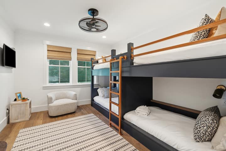 Bunkroom with fan, smart tv, and ensuite bathroom. 