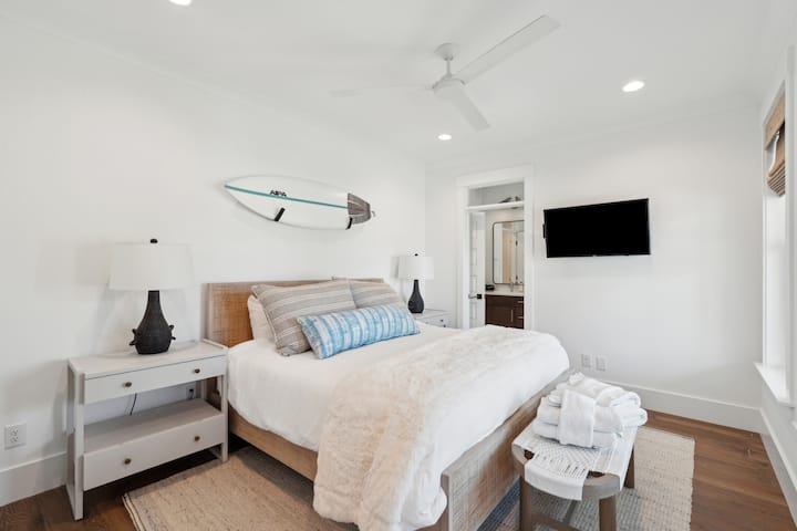 3rd bedroom with shared bath, smart tv, king bed, and fan. 
