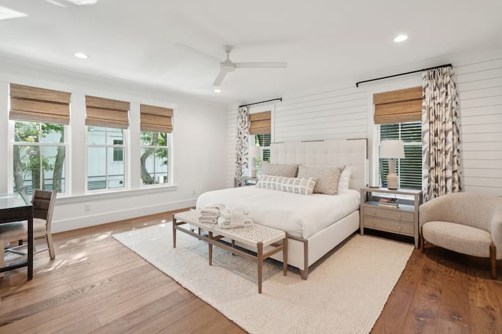 Master bedroom with king bed, fan, smart tv, desk and huge ensuite/walk in closet. 