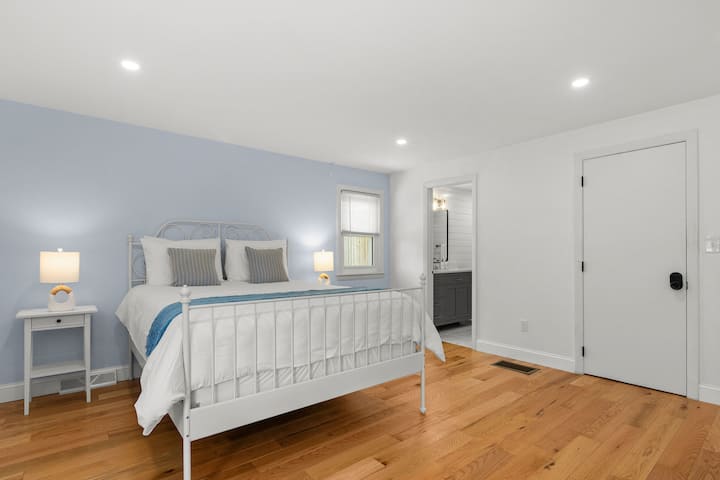Rest easy in this bedroom featuring a queen-size bed with hotel-quality linens, a full-length mirror, spacious closet, and an ensuite bathroom.
