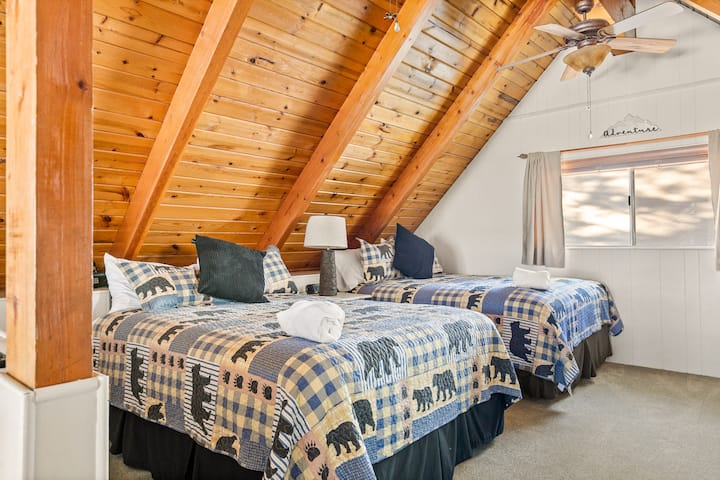 Bedroom #3: This upstairs bedroom has 2 queen beds, carpet floor, a Smart TV with streaming services, and a ceiling fan.