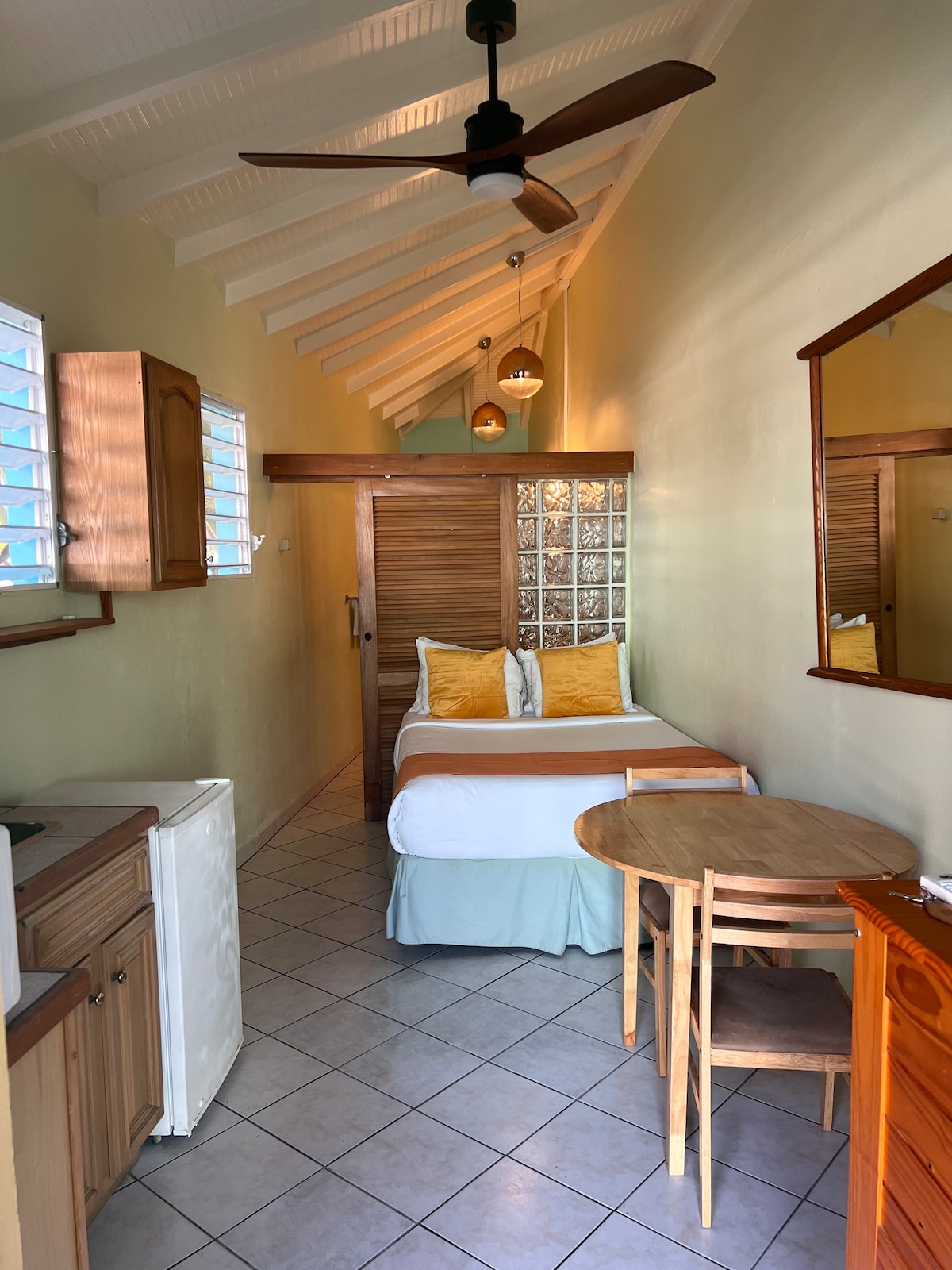 The Bay Suite is perfect for solo guests or couples that don't mind a small bed (full, a bit smaller than a queen). Compact, yet functional and priced for the budget minded traveler. 
The beach can be seen from the windows.  