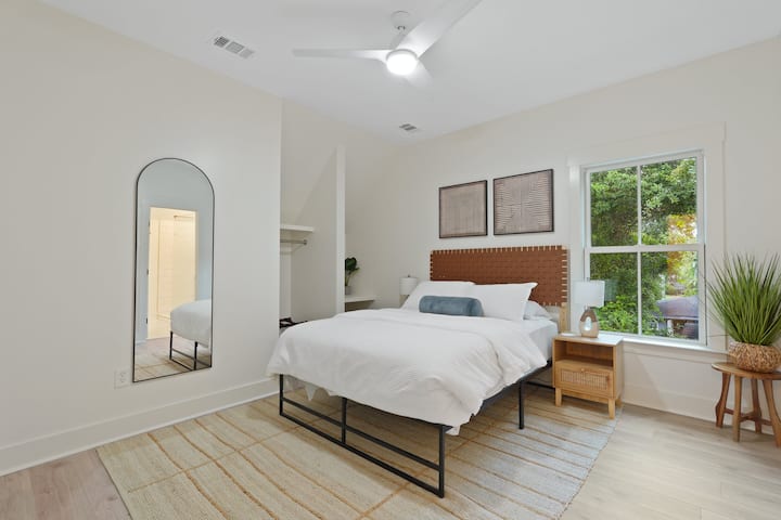 The room has a small desk area and shares a large bathroom with Bedroom 4.