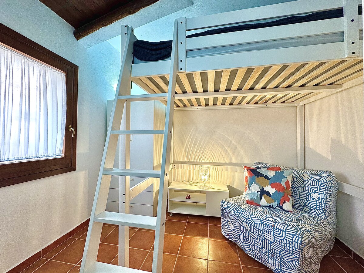 Slaapkamer 
een tweepersoonsbed in loftstijl, ruime kasten en een comfortabele stoel