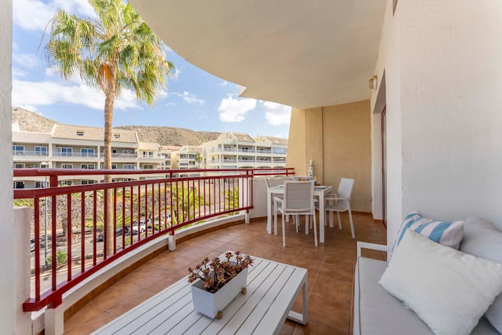Balcony breakfast table with palm and mountain views