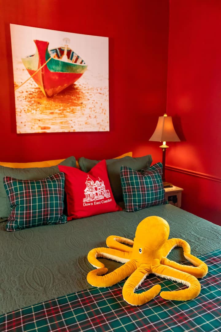 Manželská posteľ s komodou a skriňou na uloženie oblečenia.