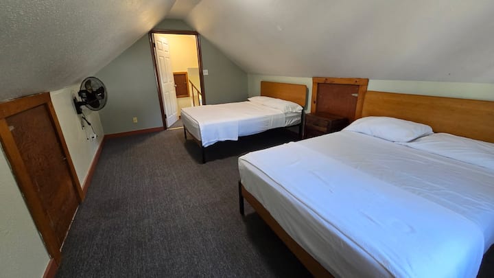 Attic bedroom with slanted ceilings is the only room on the second floor.