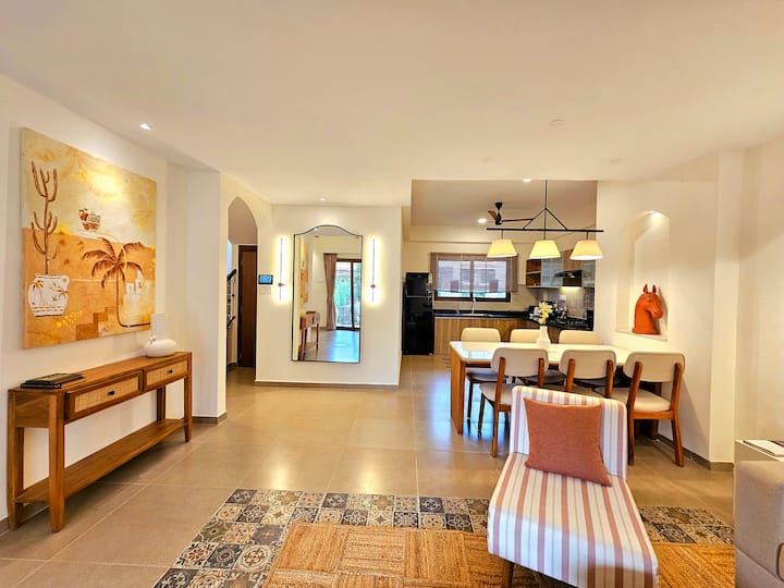 Relax in this spacious kitchen with state-of-the-art gear, a beautiful wooden dining table, and all the comforts for a delightful stay.