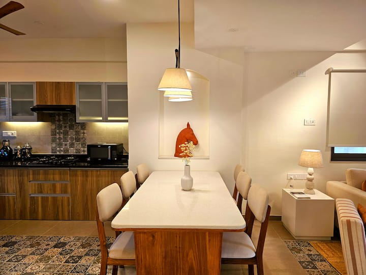 Dine in style at this luminous kitchen with a tasteful wooden table, modern appliances, and all amenities: your perfect setting for joyful gatherings!