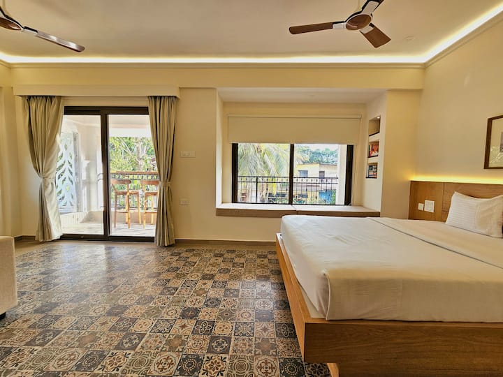 Wake up refreshed in this airy space with a queen bed, darkening blinds, outdoor balcony furniture, and warm wooden decor-your perfect cozy retreat to relax, unwind, and enjoy peaceful moments...