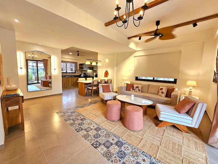 Airy space with pastel luxe touches, comfy sofa, pink puffy chairs, and mood lighting. Slide open the door and jump straight into your private pool for ultimate refreshment!