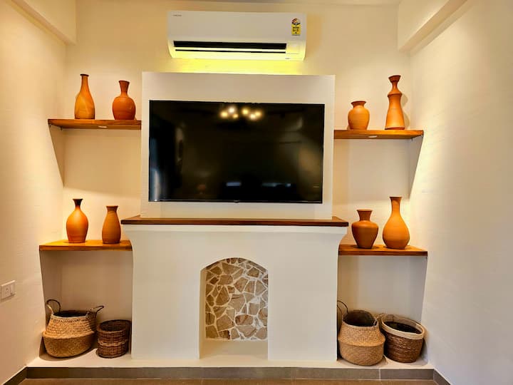 Step into this airy, earthy decor-filled living room with a smart TV: your perfect cozy retreat to relax, unwind, and create unforgettable memories in style.