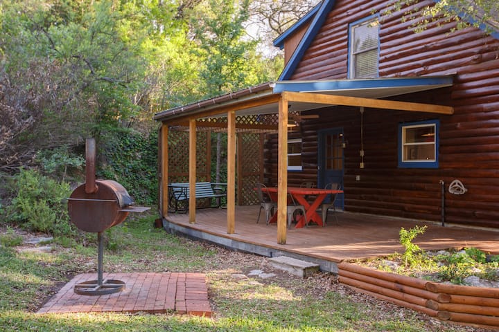Our nice charcoal grill sits beside the covered side patio. The side patio sits in a peaceful little grotto where you can hear the sounds of trickling water after a rain. It's our very favorite spot!