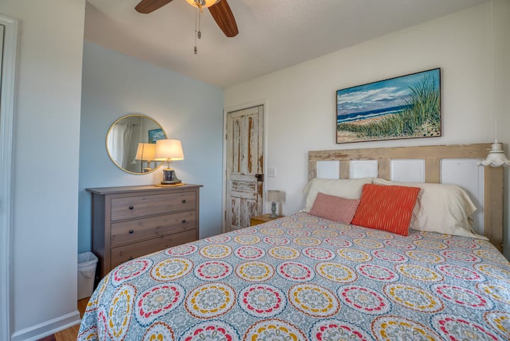 Queen bed and original artwork in the mantle room.