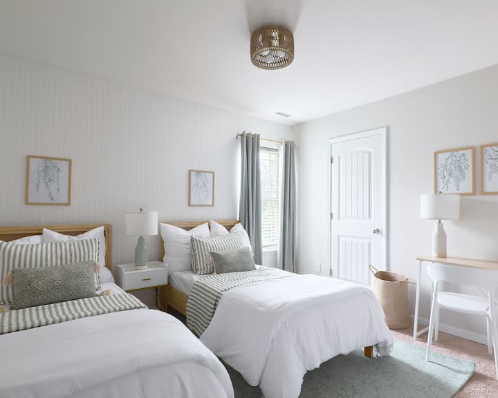 The Fern Room offers two twin beds and a dedicated workspace—perfect for restful nights and focused productivity. Also includes a 43" Smart TV with Disney Plus Hulu, Netflix, YouTube and others available.