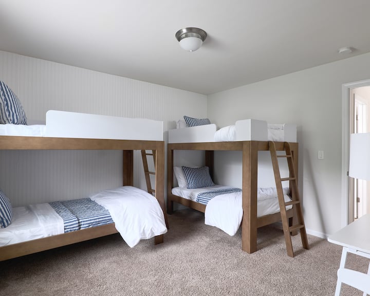 The Canopy Room features two cozy bunk beds—ideal for group stays, sleepovers, and fun-filled nights.