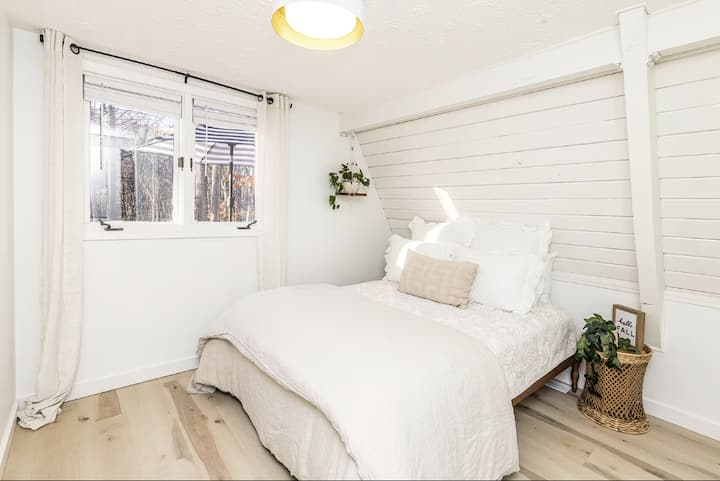 The main floor bedroom features a queen size bed, closets and built in shelves. 