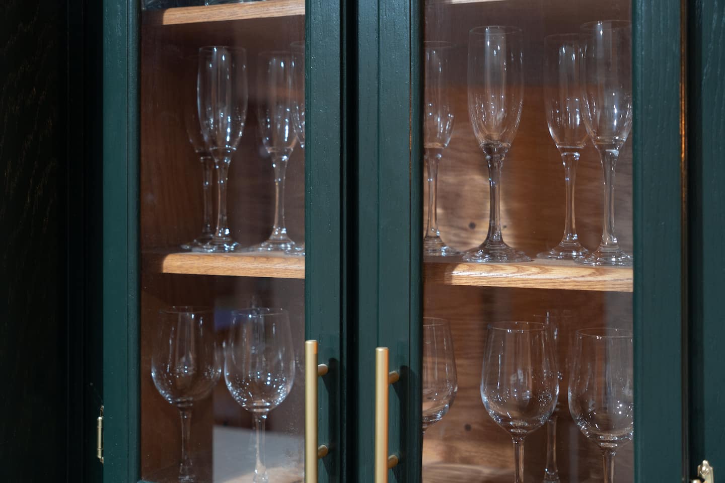 Glass-front cabinet with stemware