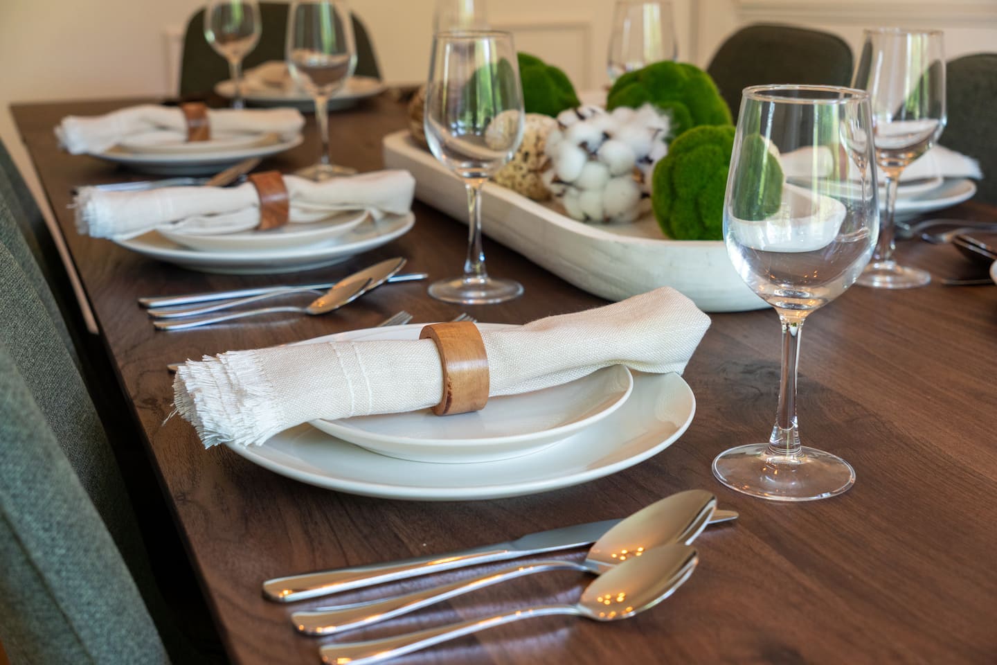 Table setting styled with wine glasses and linens