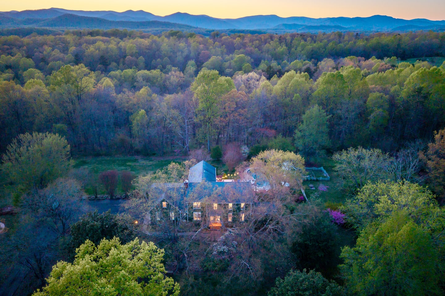 Photo 2 — Aerial view of Emerald Retreat framed by ten wooded acres