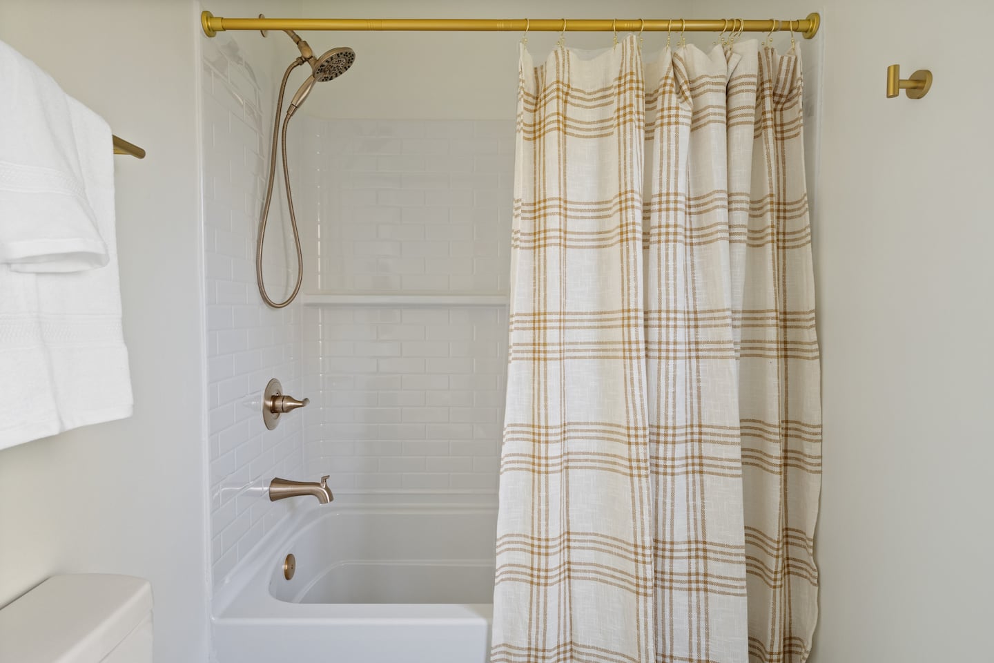Bathroom with shower and gingham curtain