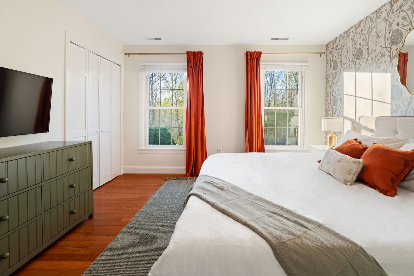 Bedroom with dresser and orange curtains