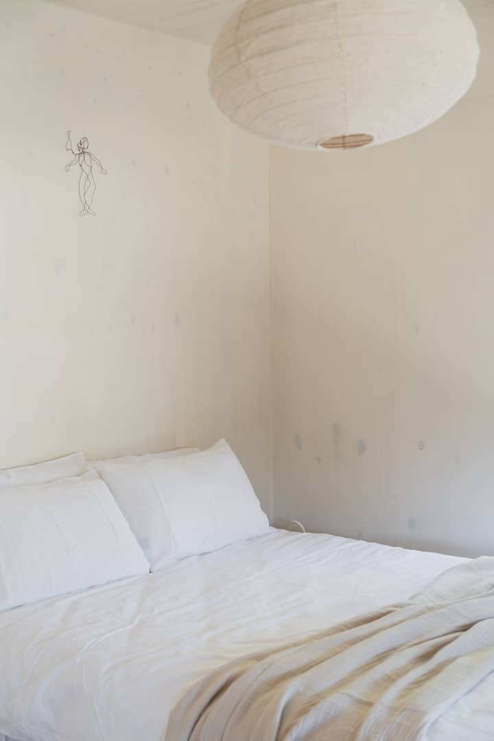 Plywood walls and underfloor heating with a double window looking out to the paddocks 