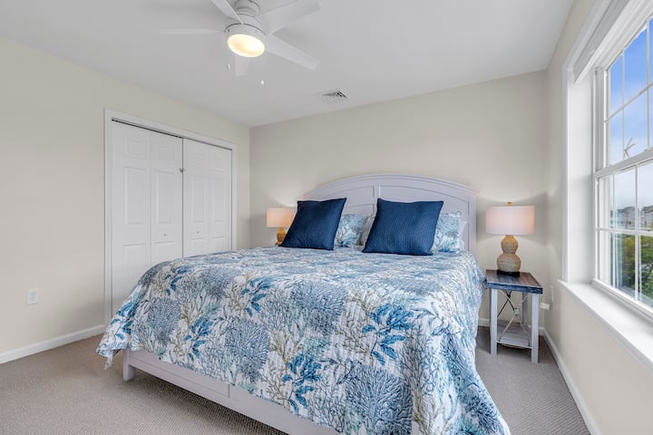 Master bedroom with King size bed • dresser • closet with hangers • ceiling fan