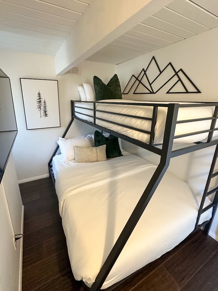 Queen and Twin XL beds and smart TV in the bunk room.