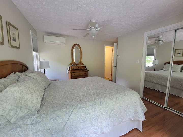 חדר שינה בקומה הראשית עם מיטת קווין סייז, חדר רחצה מלא, מאוורר תקרה ומערכת מיזוג אוויר מיני-ספלית כדי לקרר במהירות את החדר.