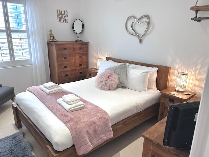 King size bed / window shutters and blackout blind.
