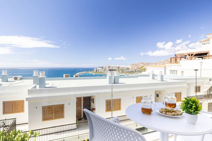 Balcony with table and panoramic sea views