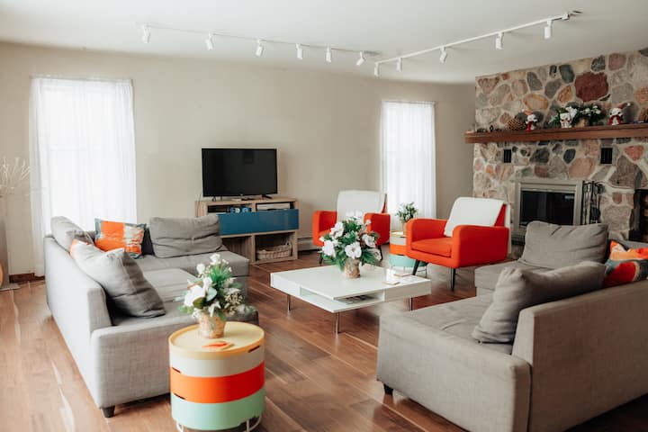 A living area with a fireplace to gather with your friends and family.