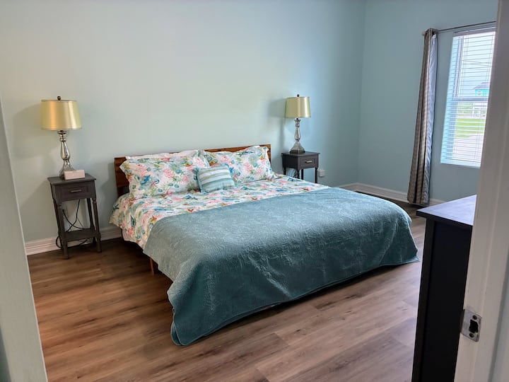 Spacious master bedroom with smart TV and ensuite access.