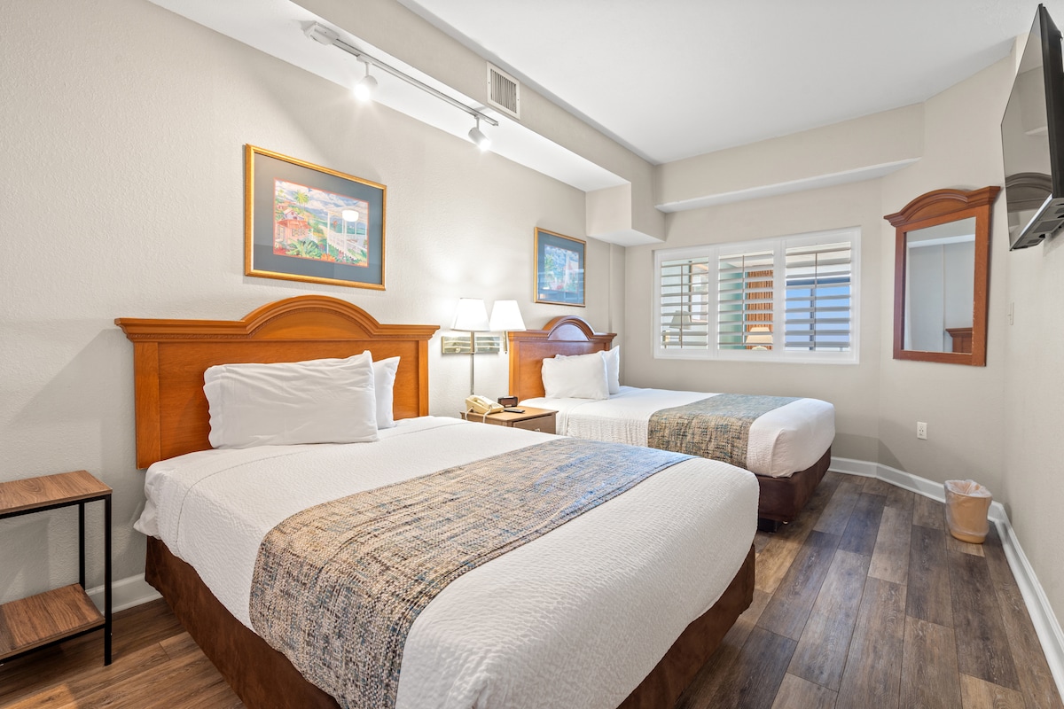 宽敞的卧室，配备两张豪华标准双人床，铺有酒店风格的床上用品。 壁挂式大屏幕智能电视面向床铺，而大镜子、宽敞的衣柜和抽屉柜则提供充足的存储空间，让您放松身心。