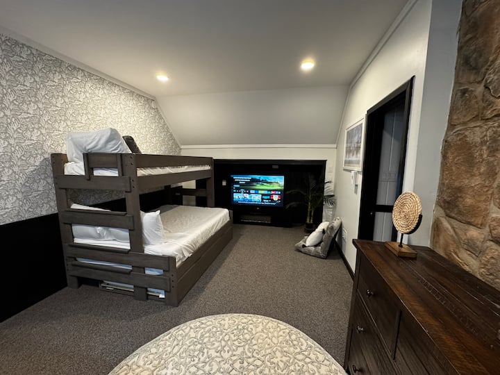 This is a three bed trundle: 1 full bed on first level, 1 twin bed upper and lower levels, and is in the loft.