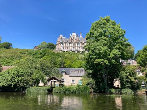 House by the river, under a castle