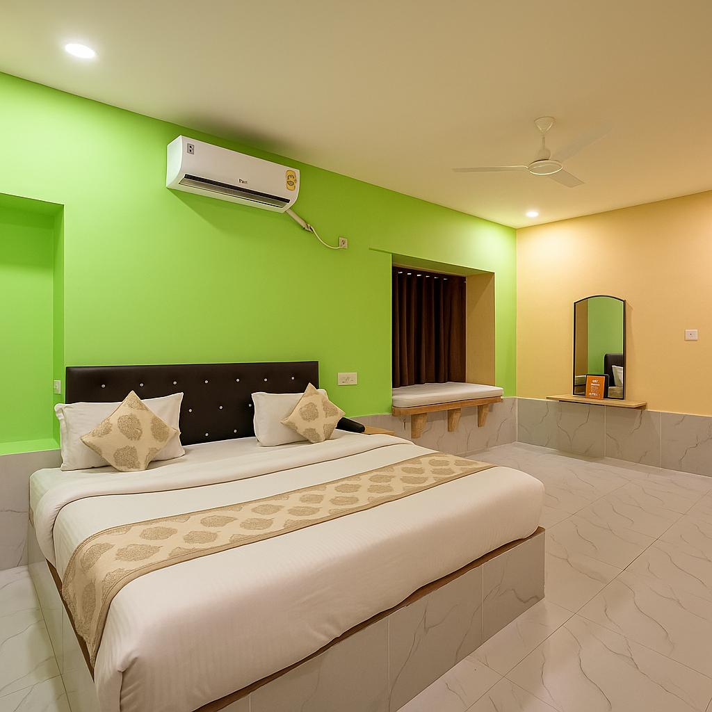A bright bedroom features a spacious bed with a decorative throw along its length. The walls are painted in vibrant green and warm yellow tones. An air conditioning unit is mounted above the bed. A mirror is positioned on the opposite wall, while a bench is placed near the window.