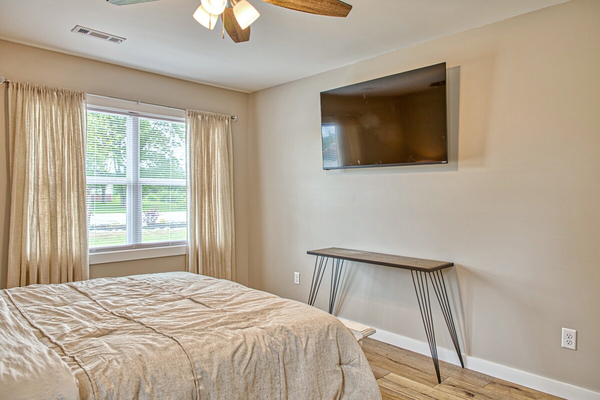 Unwind in a calming master bedroom with soft linens. Enjoy modern comforts like flat screen TV and a dedicated workspace-perfect for both relaxation and productivity. This space has direct access to private master bathroom and large walk-in closet. 