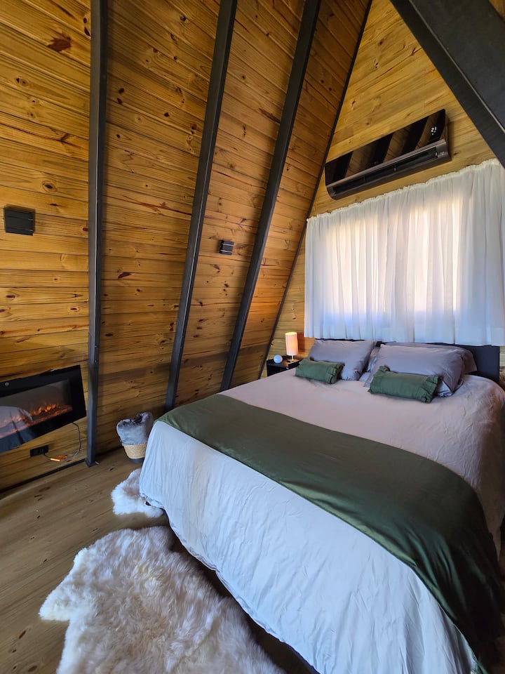 Queen-size bed with Egyptian cotton bedding, electric fireplace and air conditioning for total comfort.