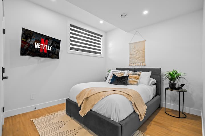  Modern boho vibes meet comfort — smart TV, blackout blinds, and layered textures for a dreamy night in.