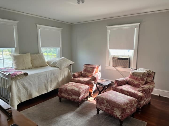 One of the upstairs bedrooms is set up as a TV room with 2 chairs and a daybed.