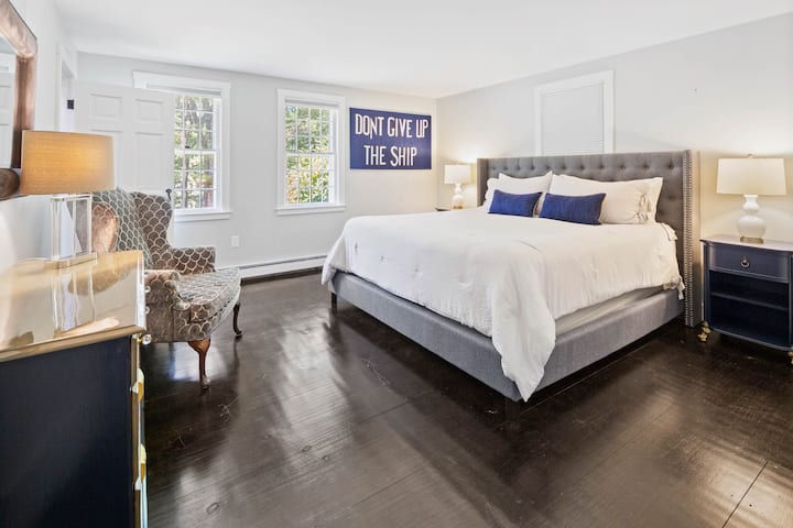 First-floor master bedroom with king-size bed, cozy linens, and bedding for a great night's rest.