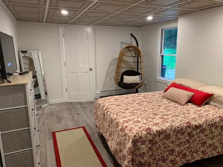 غرفة النوم الرابعة، سرير كبير بزاوية رأس قابلة للتعديل، مع نافذة تواجه الفناء الخلفي. نزهة في الطابق السفلي إلى الفناء الخلفي  (كرسي في الصورة على الشرفة، وهناك مكتب في ذلك المسكن الآن).  