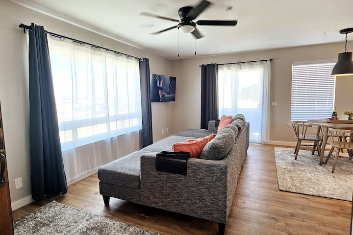 RELAX. Unwind in the cozy living room with a 65" SMART tv. The couch turns into a GIANT ottoman/king size sleeping surface perfect for two kiddos! Sheets, pillows and blankets are provided. Enjoy the GIANT 96" window with ocean views and cool breeze!