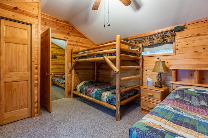 Bedroom with full bed and twin bunks.  Access to deck and view of lake.  