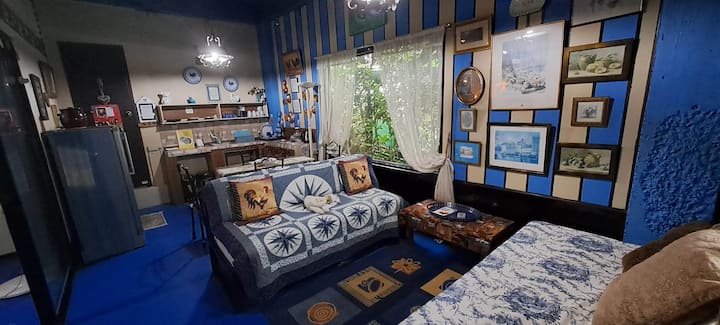 private living/dining in the suite with 1 queen size bed and a sofa