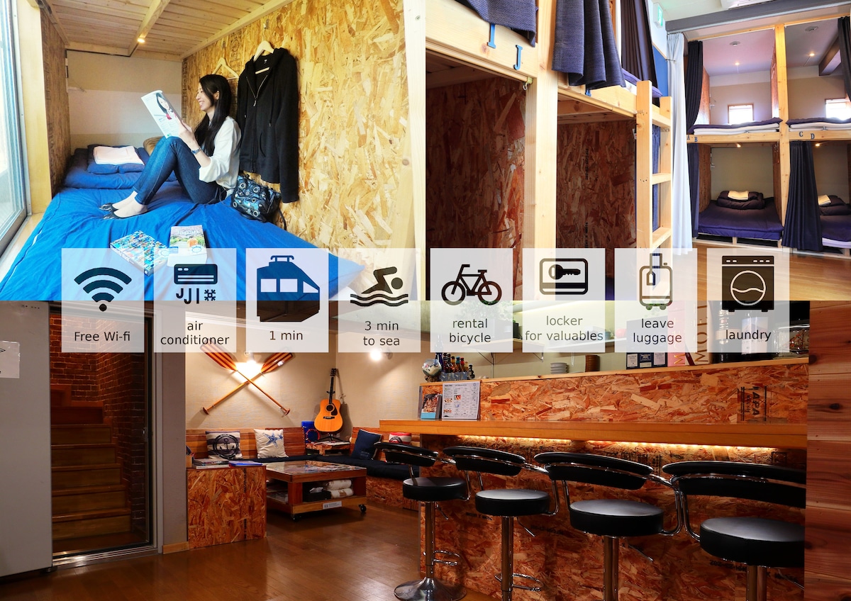 A modern dormitory room features a cozy sleeping area with a person reading on a top bunk bed. The room is designed with warm wood accents and includes personal space with curtains. Amenities like free Wi-Fi, air conditioning, and communal lounge space are also visible.