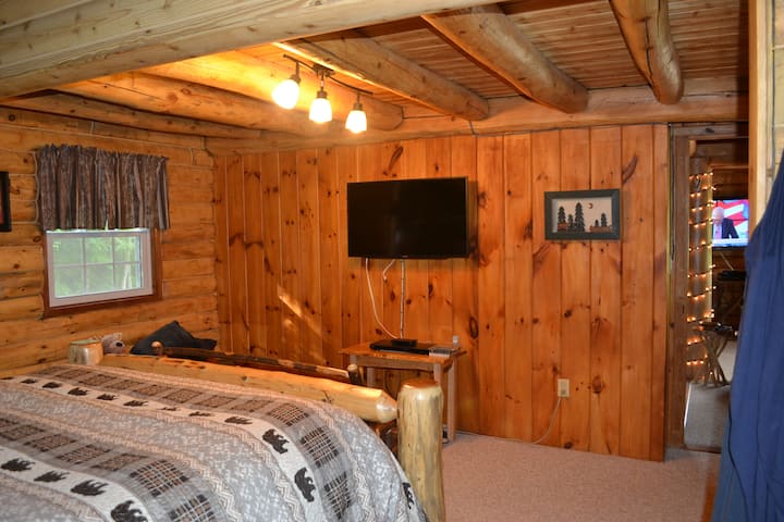 second half of the master bedroom with TV
